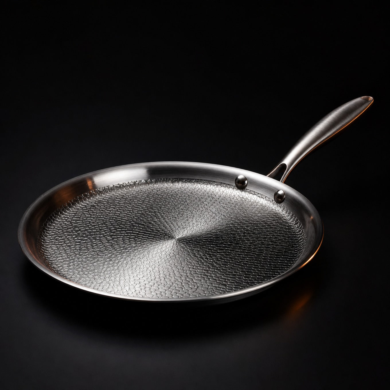 Hand-hammered flat titanium crêpe pan cooking a crêpe, PFAS-free cookware